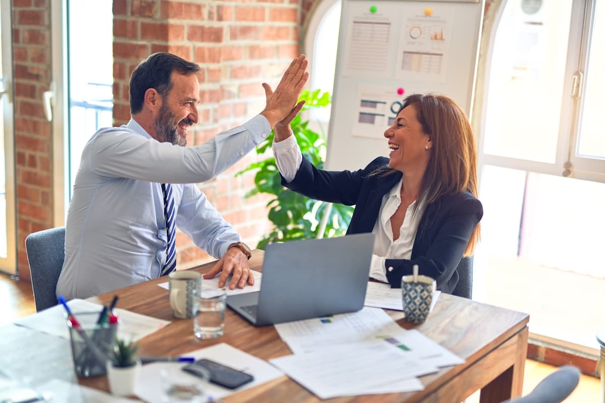 Two colleagues shaking hands after a successful project partnership